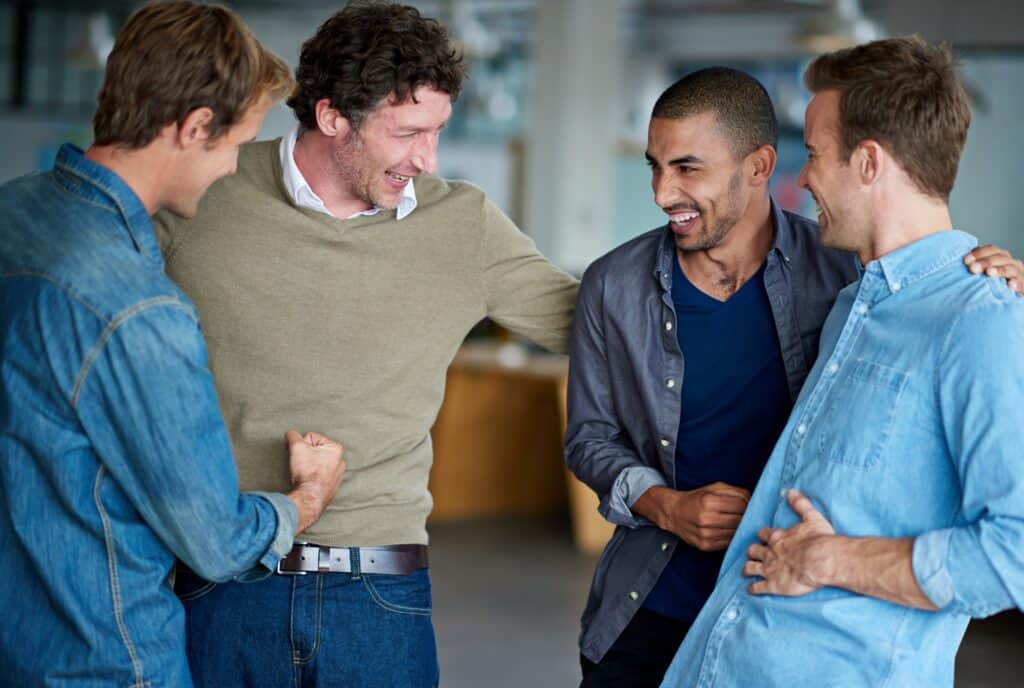 Group of men talking at outpatient mental health austin.